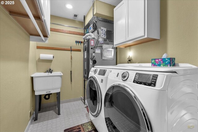 15645 NE Russell Pl, Portland, OR 97230 - laundry area with cabinet space, washer and dryer, and light flooring