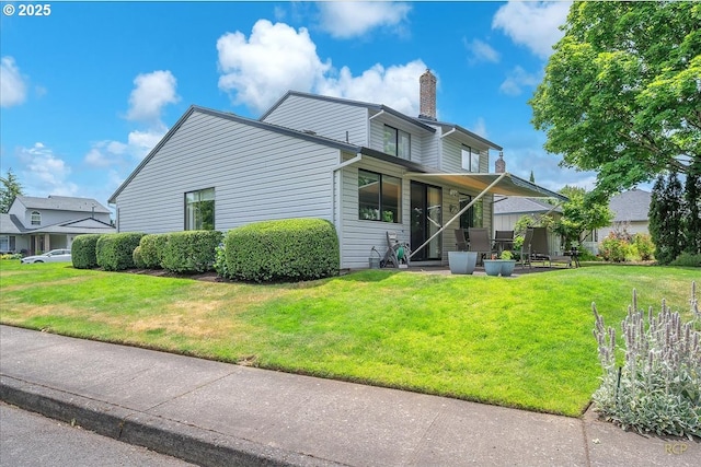 15645 NE Russell Pl, Portland, OR 97230 - rear view of property featuring a chimney and a yard