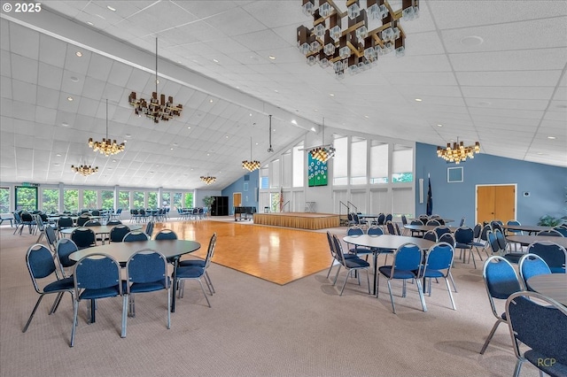 15645 NE Russell Pl, Portland, OR 97230 - carpeted dining space with high vaulted ceiling, a chandelier, and a drop ceiling