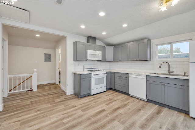 kitchen featuring sink, white appliances, gray cabinets, and vaulted ceiling