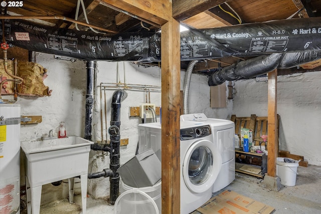 clothes washing area with strapped water heater, separate washer and dryer, and sink