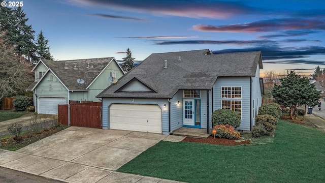 view of front facade with a garage and a lawn