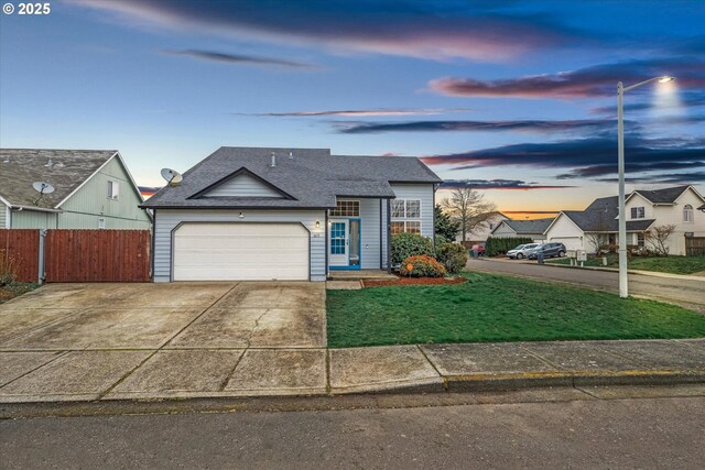 view of front of home featuring a garage and a yard