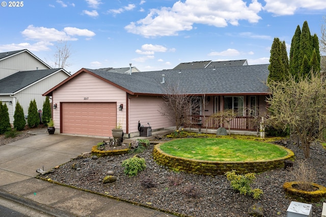 ranch-style home featuring an attached garage, covered porch, driveway, and roof with shingles