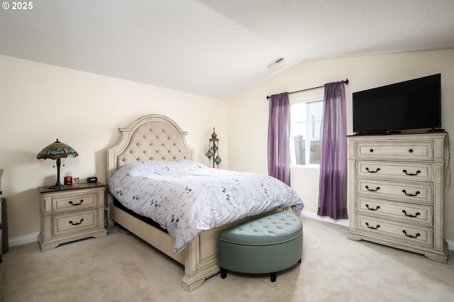 bedroom featuring vaulted ceiling, light colored carpet, visible vents, and baseboards