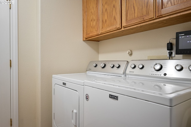 laundry area with cabinet space and washer and clothes dryer