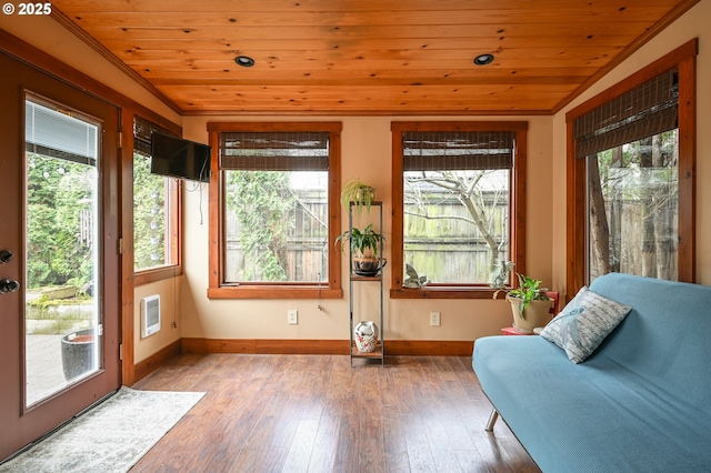 unfurnished sunroom featuring a wealth of natural light, heating unit, wooden ceiling, and lofted ceiling