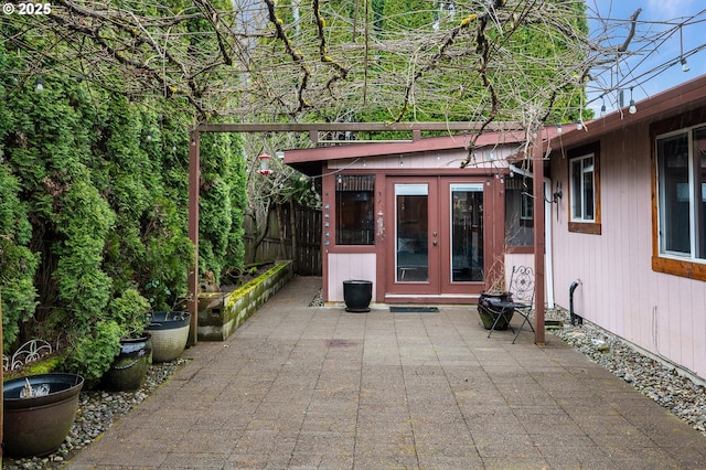 view of patio / terrace featuring french doors and fence