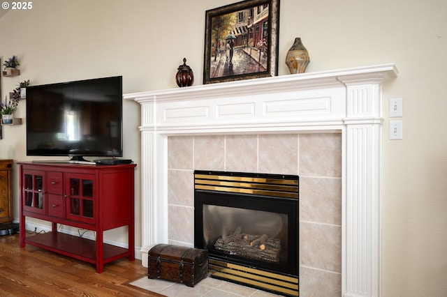 interior details featuring wood finished floors and a fireplace