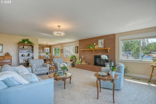 1329 NW Horn Ave, Pendleton, OR 97801 - carpeted living area with a chandelier, a brick fireplace, and baseboards