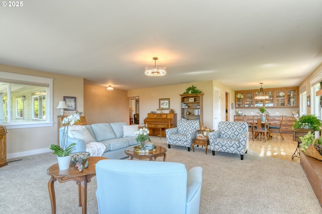 1329 NW Horn Ave, Pendleton, OR 97801 - living room featuring a chandelier, light colored carpet, and plenty of natural light