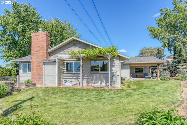 1329 NW Horn Ave, Pendleton, OR 97801 - back of house featuring a yard, a chimney, a patio area, and a pergola
