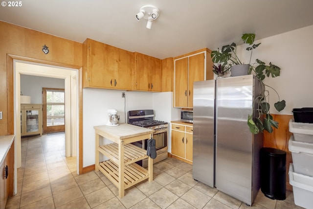 kitchen featuring light tile patterned floors and appliances with stainless steel finishes