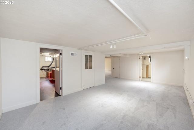 empty room with carpet floors and a textured ceiling