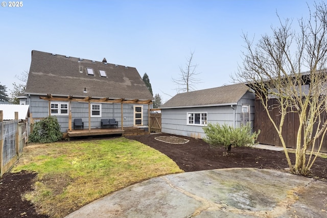 rear view of property with a wooden deck, a patio area, and a lawn