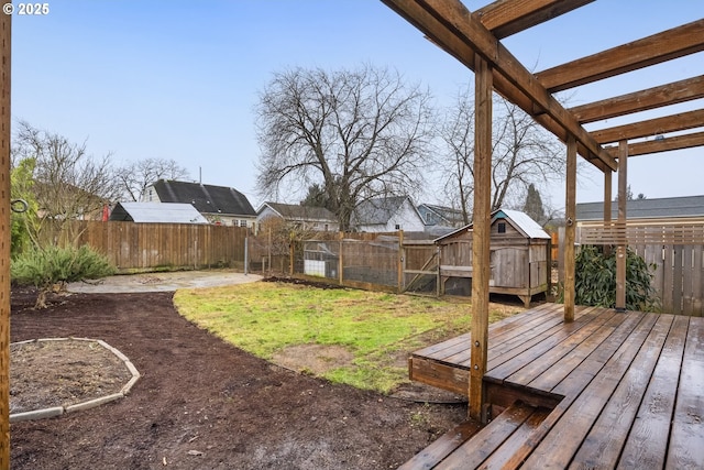 view of yard with a wooden deck and a storage unit