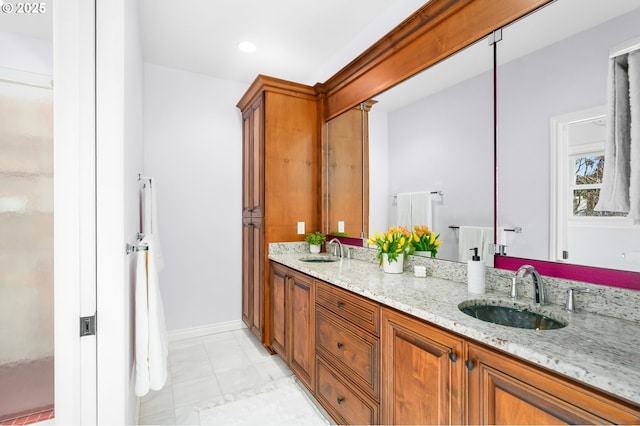bathroom featuring a sink, baseboards, double vanity, and recessed lighting