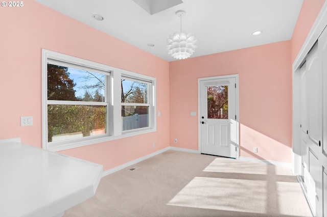 entryway featuring light colored carpet, visible vents, recessed lighting, baseboards, and a notable chandelier