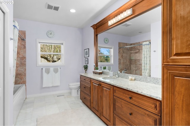 bathroom with toilet, vanity, baseboards, and visible vents