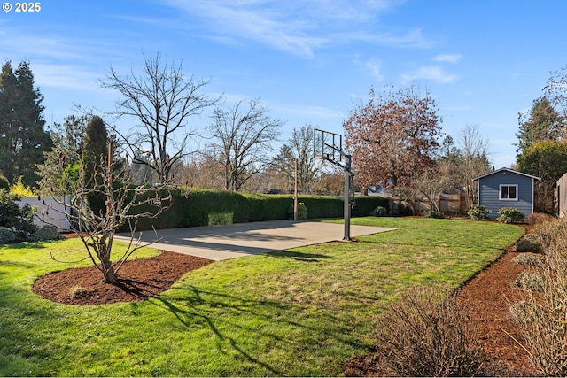 view of yard featuring basketball court and an outdoor structure