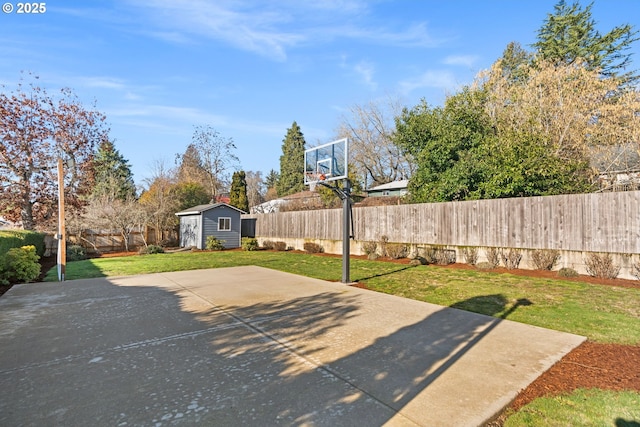 view of patio / terrace with a fenced backyard, an outdoor structure, and a storage unit