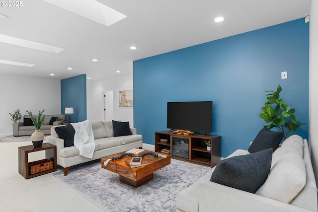 living room with a skylight, recessed lighting, and baseboards