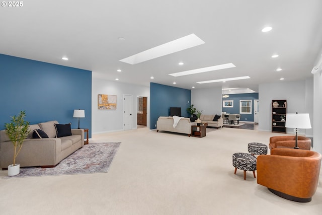 living area featuring a skylight, carpet flooring, and recessed lighting