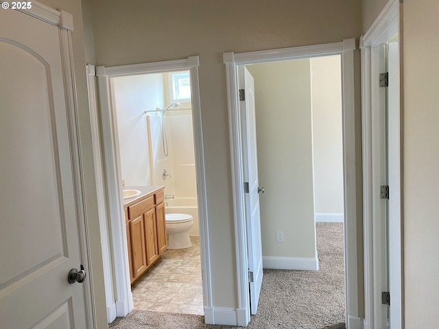 full bath with vanity, toilet, baseboards, and tub / shower combination