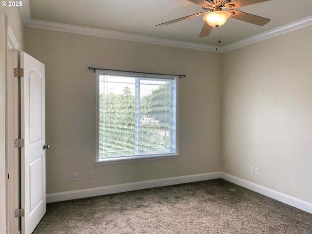 unfurnished room with ornamental molding, carpet flooring, baseboards, and ceiling fan
