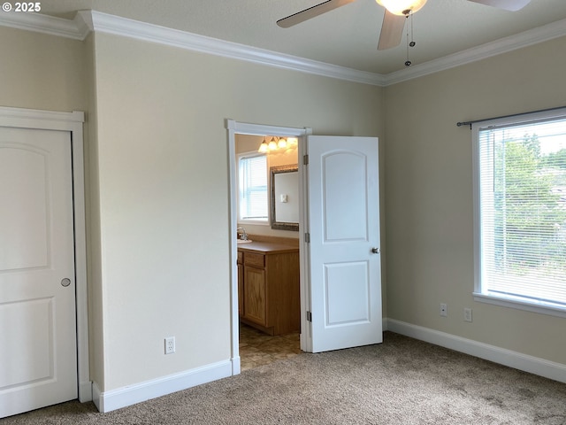 unfurnished bedroom featuring ornamental molding, light colored carpet, multiple windows, and baseboards