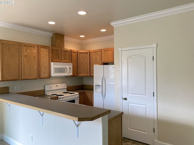 kitchen with white appliances, brown cabinetry, a peninsula, a kitchen breakfast bar, and crown molding