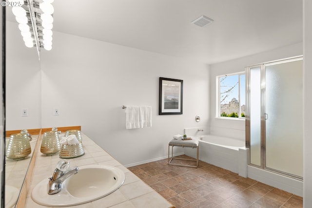 bathroom with vanity and separate shower and tub