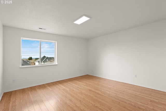 spare room with light wood-type flooring