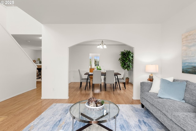 living room with hardwood / wood-style flooring and an inviting chandelier