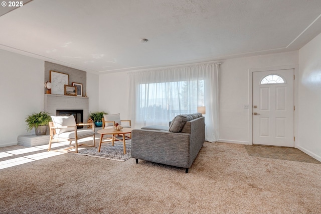 living room with carpet floors, a brick fireplace, and baseboards