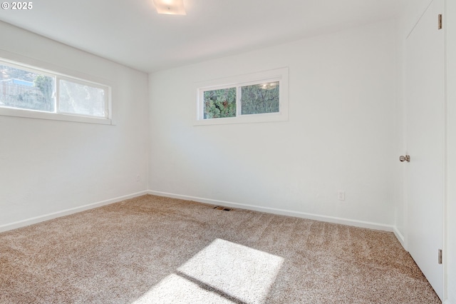 empty room with baseboards and carpet flooring