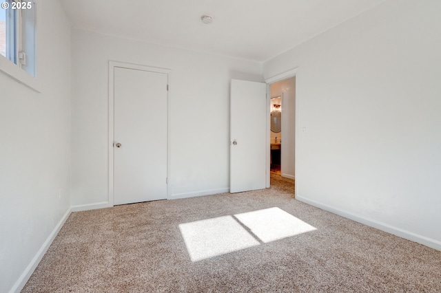 unfurnished bedroom with carpet and baseboards