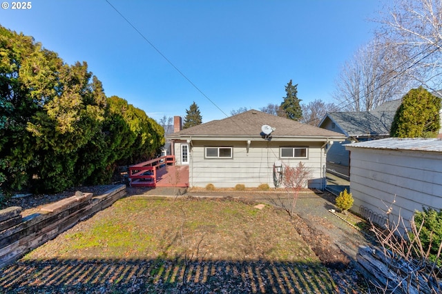 rear view of house featuring a deck