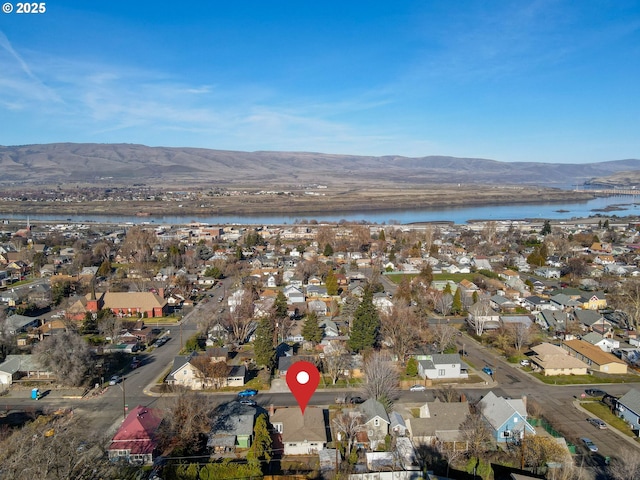 drone / aerial view with a residential view and a water and mountain view