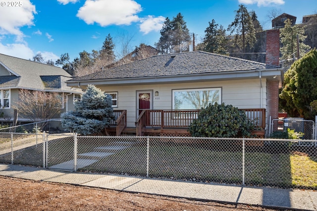 view of front of house with a fenced front yard and a chimney