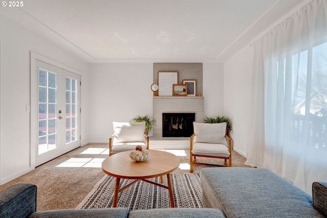 living room with carpet floors, french doors, a fireplace, and baseboards