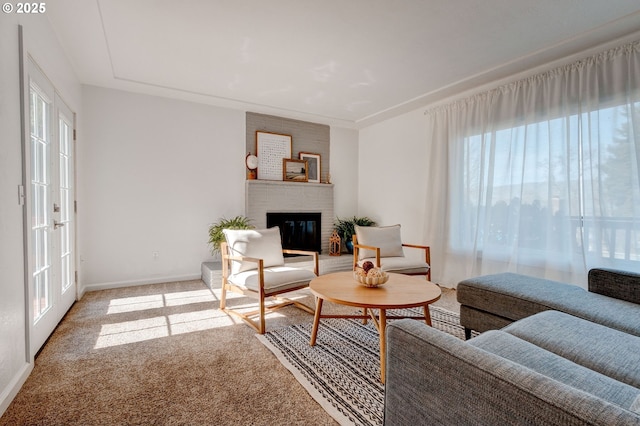 carpeted living room with a fireplace, a wealth of natural light, and baseboards