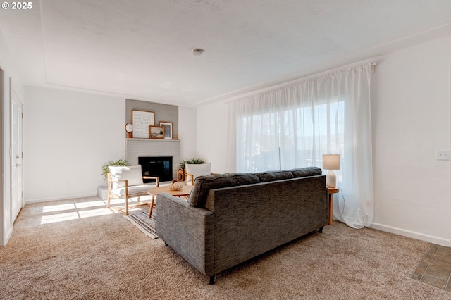 carpeted living room with a fireplace and baseboards