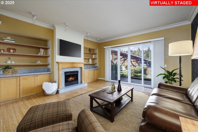 kitchen with wallpapered walls, light wood finished floors, a peninsula, crown molding, and a sink