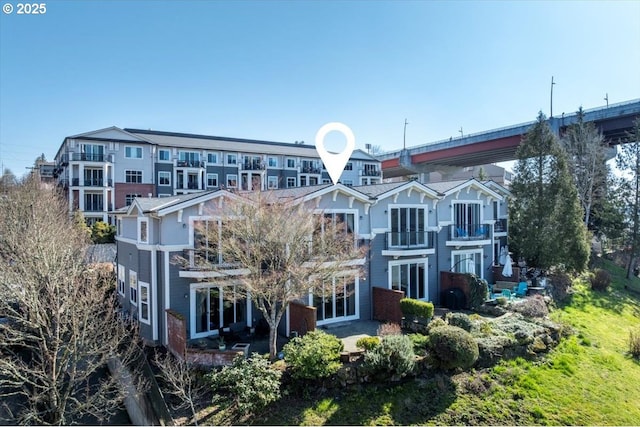 back of property with a patio and a balcony