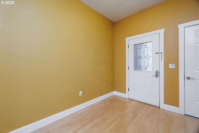 foyer entrance featuring light wood-type flooring and baseboards