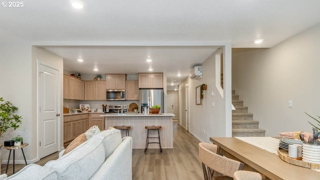 6161 SE 15th St, Gresham, OR 97080 - kitchen featuring stainless steel appliances, light brown cabinetry, open floor plan, light countertops, and an island with sink