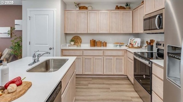 6161 SE 15th St, Gresham, OR 97080 - kitchen featuring appliances with stainless steel finishes, light brown cabinetry, light wood-style flooring, and light countertops