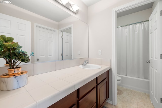 bathroom featuring toilet, shower / bath combo, and vanity