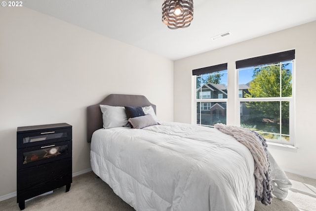 carpeted bedroom with visible vents and baseboards